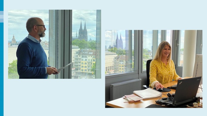 Links: Ein Mann im blauen Pullover (Ulrich) steht mit Papieren in der Hand vor einem Bürofenster und blickt nach rechts. Durch das Fenster sieht man den Kölner Dom. Rechts: Eine Frau in einer gelben Bluse (Laura) sitzt an einem Schreibtisch und arbeitet am Computer. Durch das Fenster sieht man den Kölner Dom.